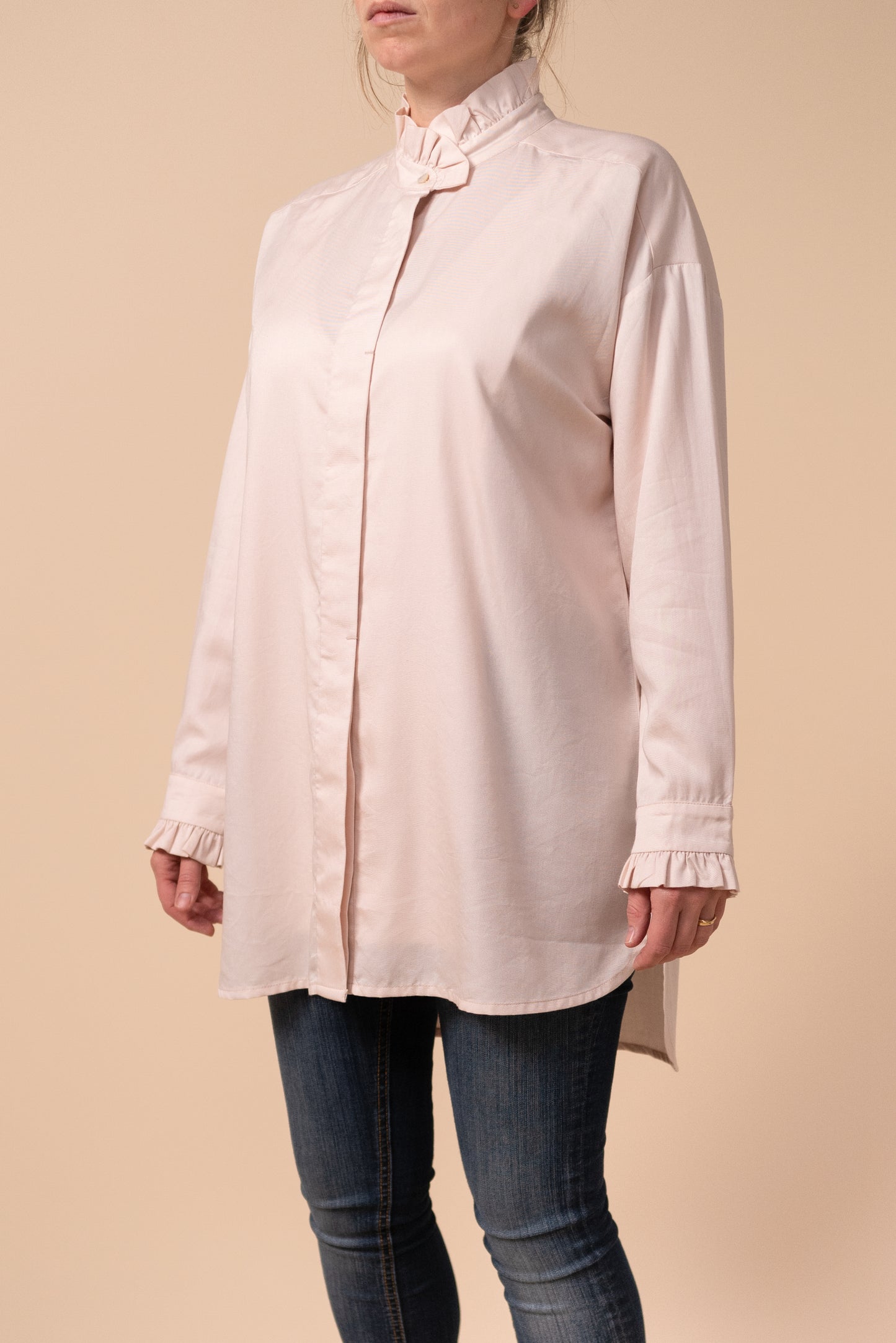 Front and side view of Effin's breastfeeding friendly light pink blouse showing the ruffles on the neck and cuffs with buttons done up all the way