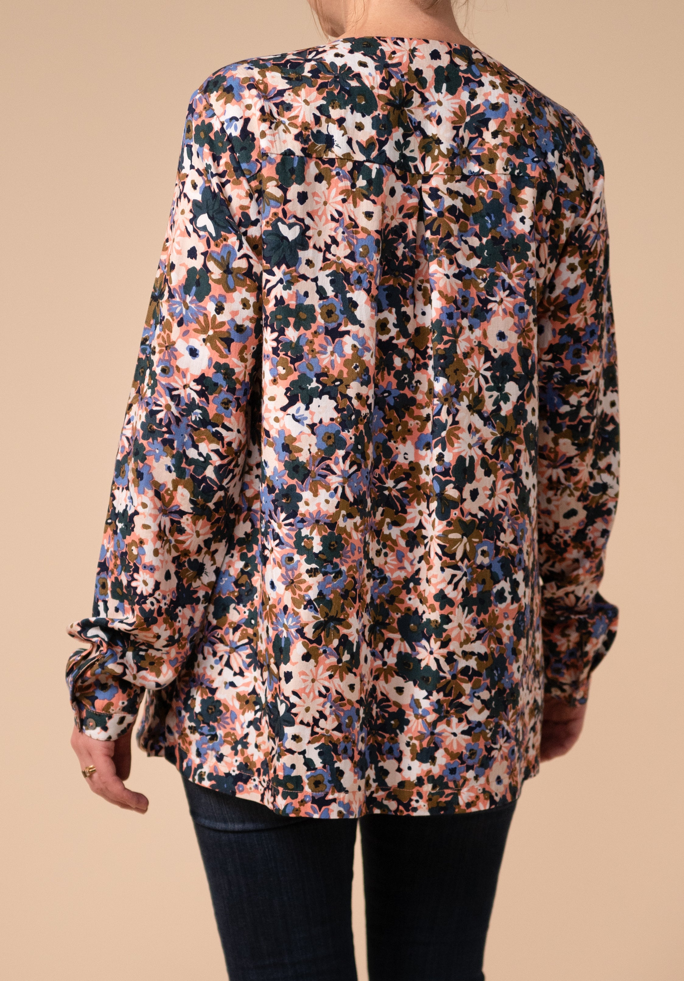 Image of the back of Effin's floral wrap nursing blouse