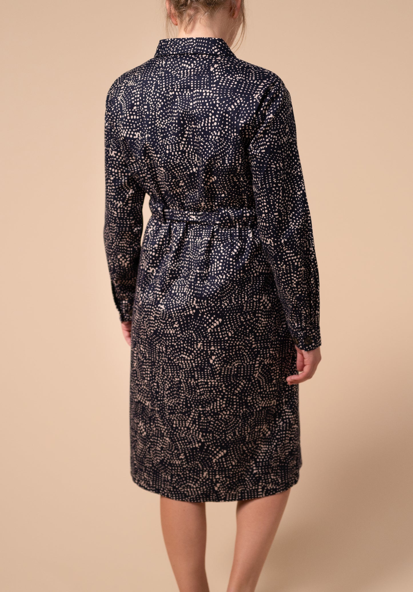 Back view of navy and light pink spotty breastfeeding friendly shirt dress with mother of pearl buttons