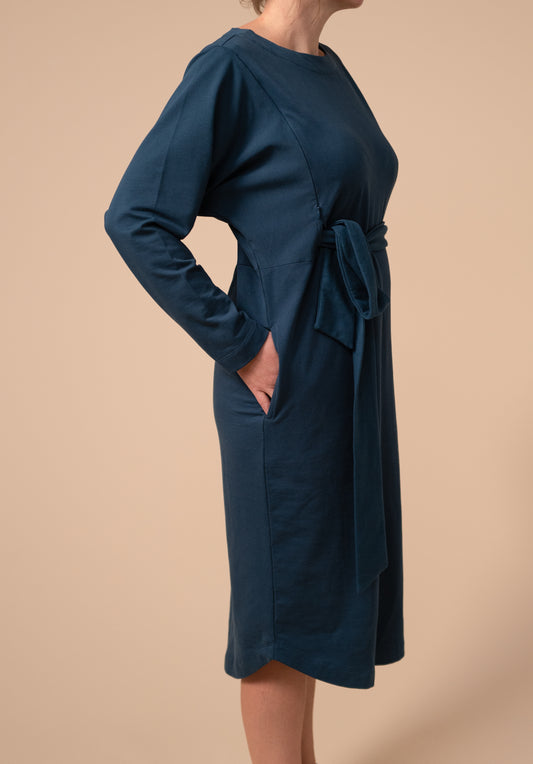 Side view showing off the pockets on the drape tie dress